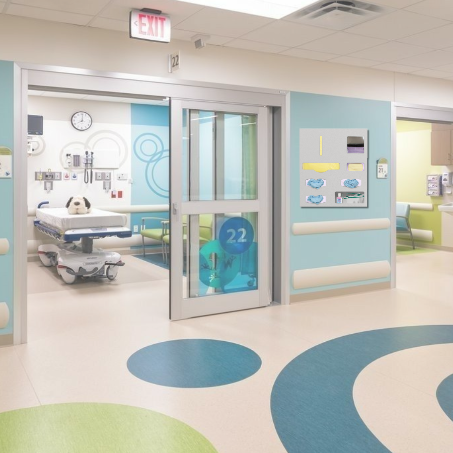 Pediatric patient care area and room with a hall view and an Origin Protection System hanging on the wall with gowns, gloves and masks in it.