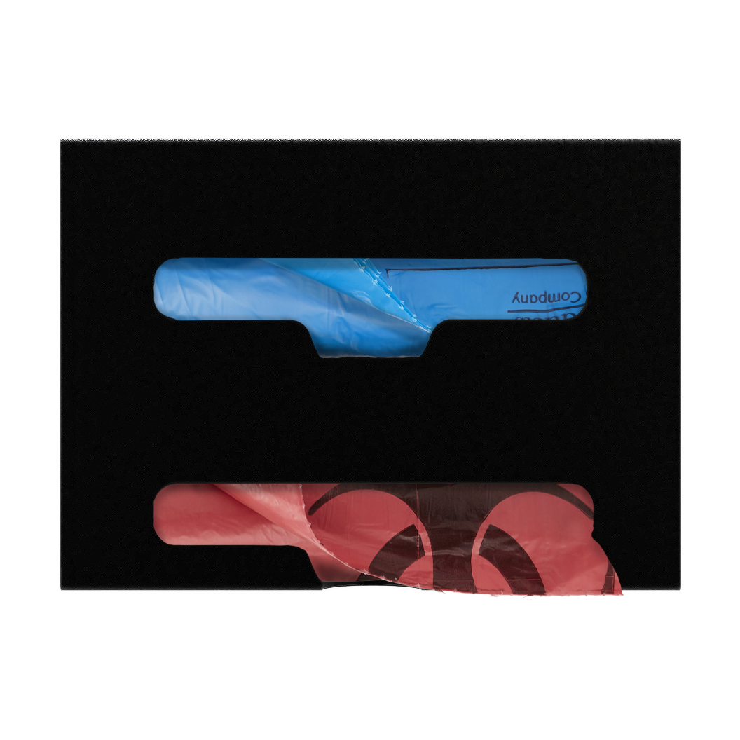Black, double compartment bag dispenser with side hole for loading and front bottom hole for dispensing. Filled with linen and biohazard bags.,