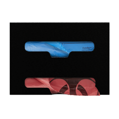 Black, double compartment bag dispenser with side hole for loading and front bottom hole for dispensing. Filled with linen and biohazard bags.,